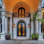 Grand entrance with Cantera hand forged iron doors.